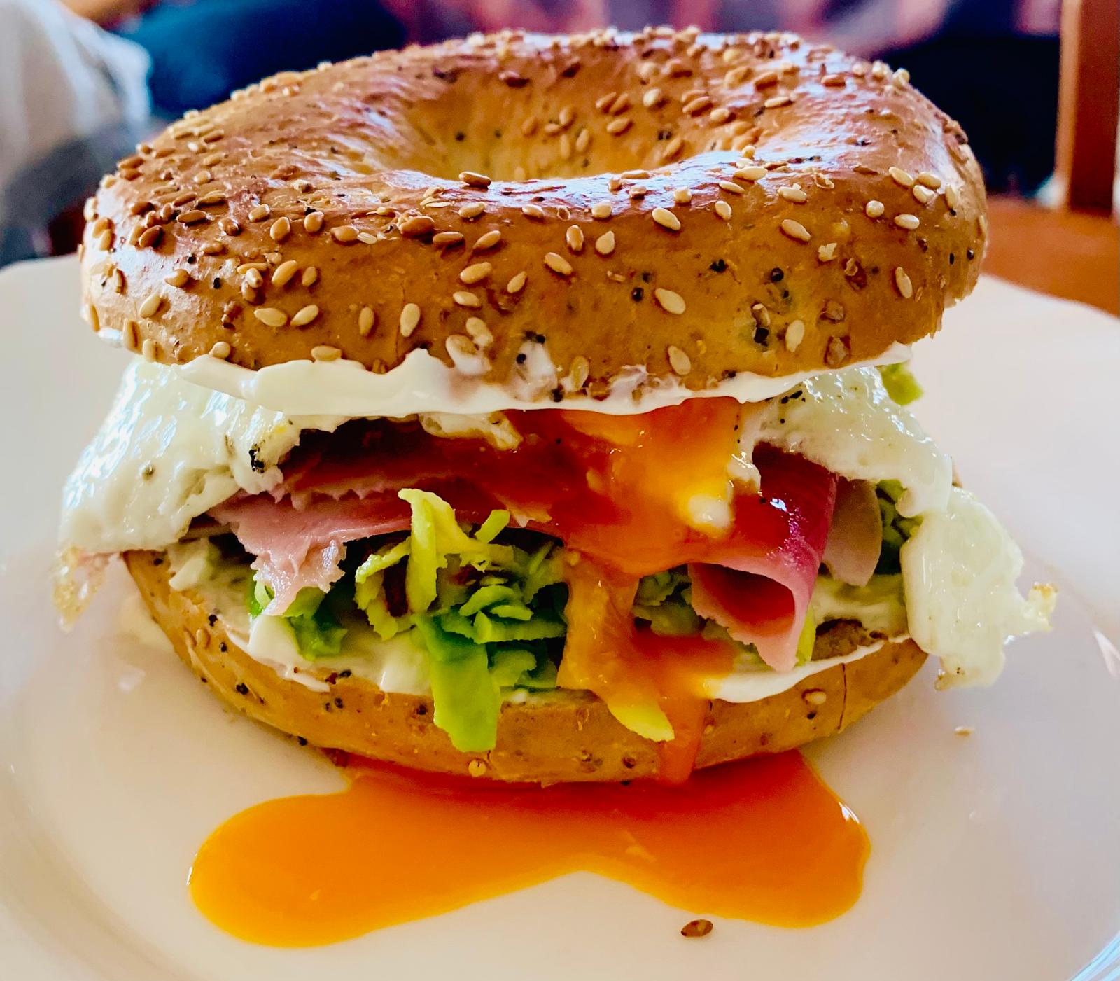 Bagel with cream cheese, avocado, jamón serrano and fried egg